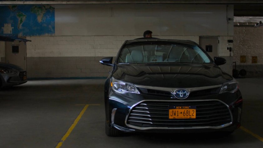 Malcolm getting out of Trish's trunk in a parking garage.