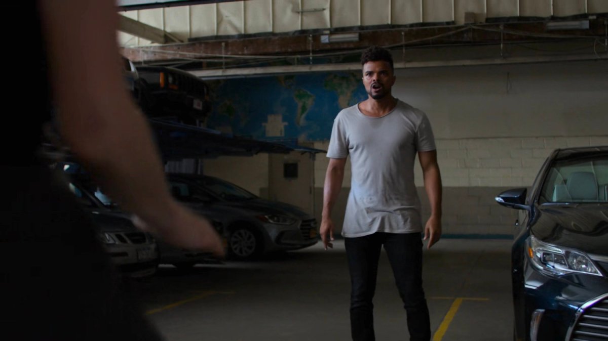 Malcolm in a parking garage.