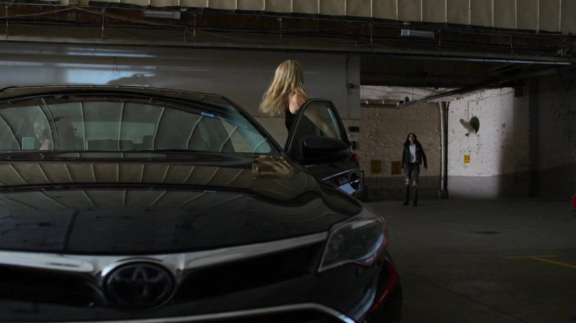 Jessica heading for Trish's car in a parking garage.