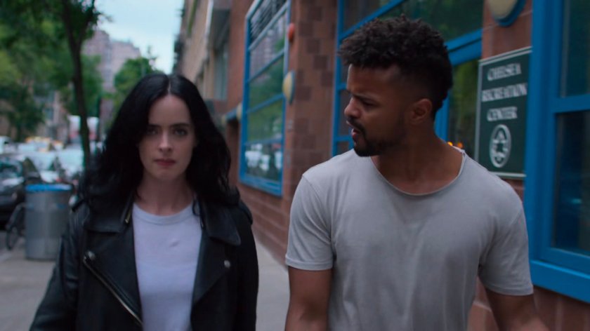 Jessica and Malcolm walking on a sidewalk.