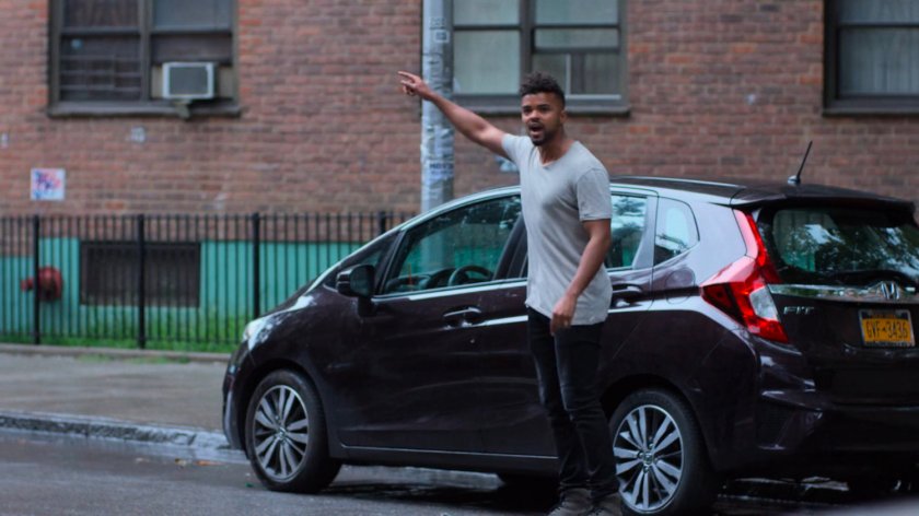 Malcolm pointing along a street.