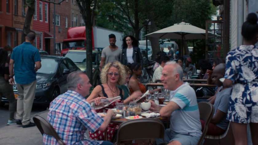 Malcolm and Jessica on the sidewalk outside patio diners.