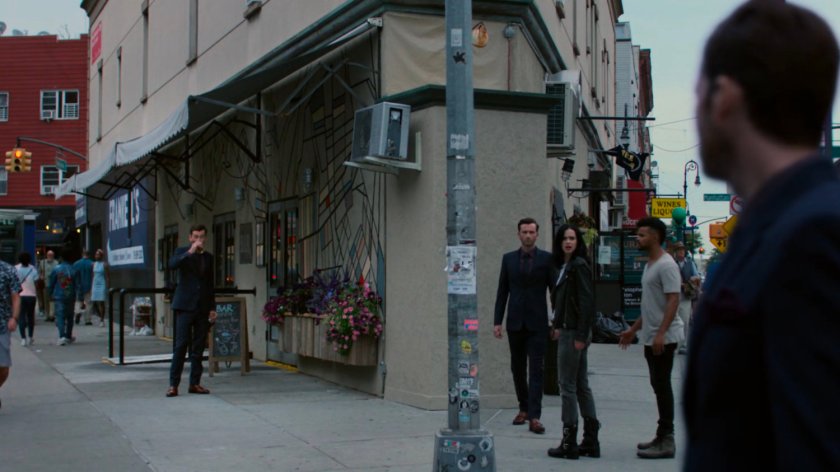 Multiple Kilgraves speaking with Malcolm and Jessica on the sidewalk.