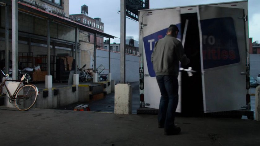 Supervisor standing by a truck on a loading dock.
