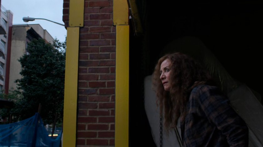 Alisa leaving a warehouse.