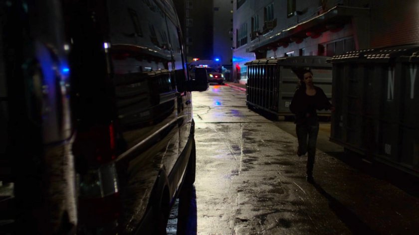 Jessica running towards a mortuary van outside Riverbank Medical Center.