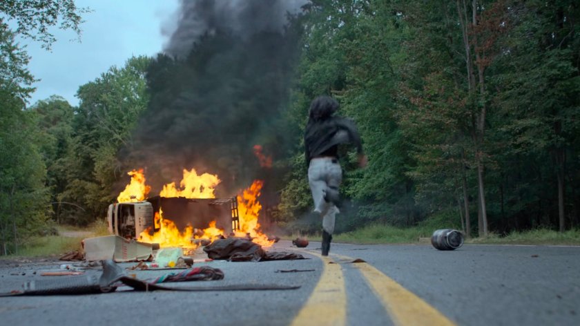 Jessica running towards a flaming car flipped on a Westchester road.
