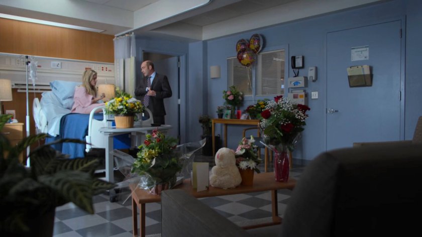 Trish and Detective Costa in a Riverbank Medical Center room.