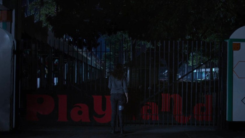 Alisa outside Playland amusement park at night.
