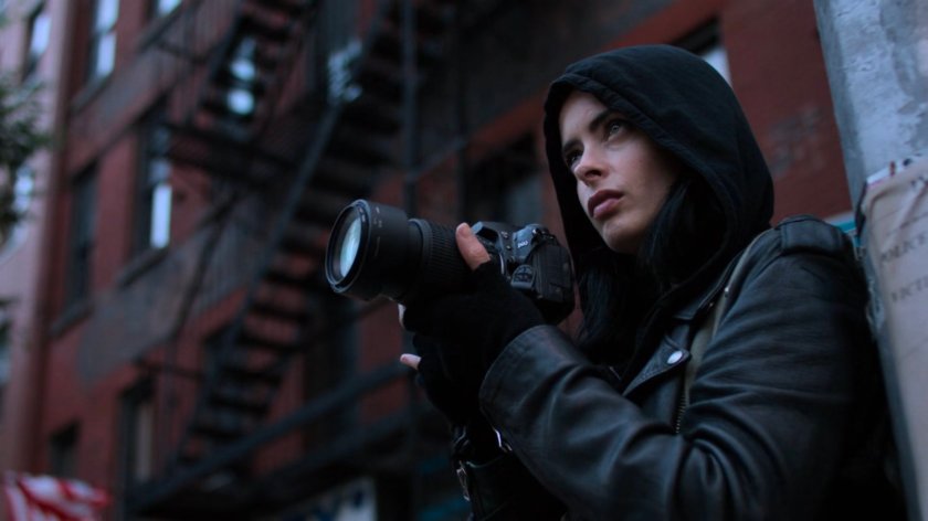 Jessica taking photos outside a building.