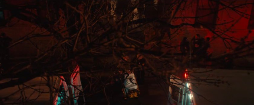 Exterior of Cherry's apartment with two ambulances out front.