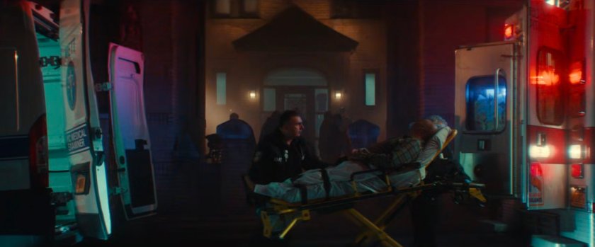 Exterior of Cherry's apartment with two ambulances out front.