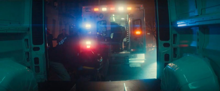 Exterior of Cherry's apartment with two ambulances out front.
