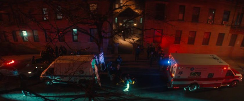 Exterior of Cherry's apartment with two ambulances out front.
