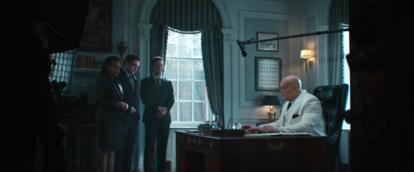 Mayor Fisk giving a speech from his office while Sheila, Daniel and Buck look on.