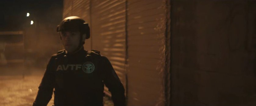 An AVTF officer in the alley behind Josie's bar.