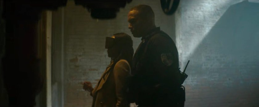 Cole leads Kirsten through the Red Hook detention center.