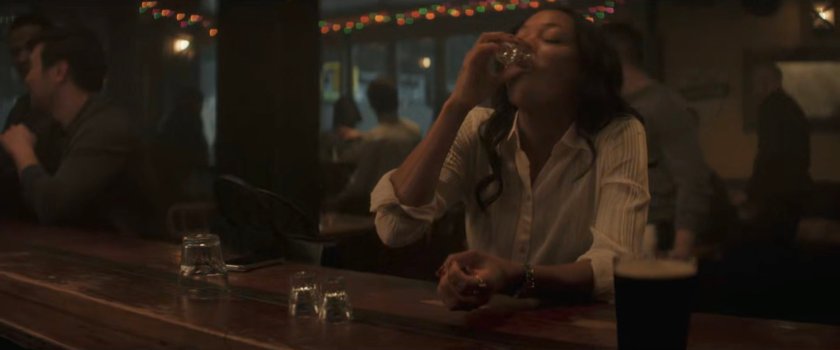 Kirsten having a drink at a bar.