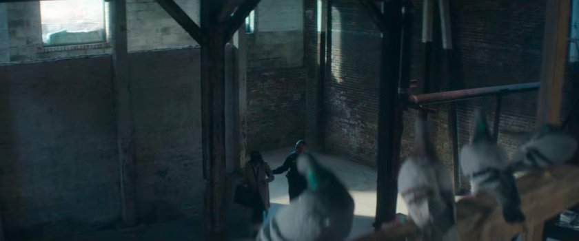 Cole leading Kirsten past pigeons in the Red Hook port detention facility.