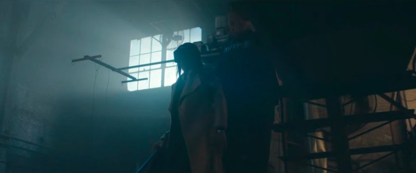 Cole leading Kirsten down stairs in the Red Hook port detention facility.