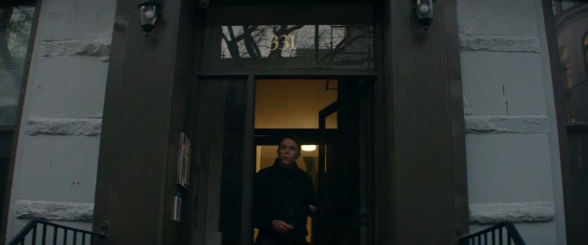 Dex exiting his apartment building.