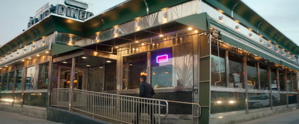 Dex entering the Bel Aire diner.