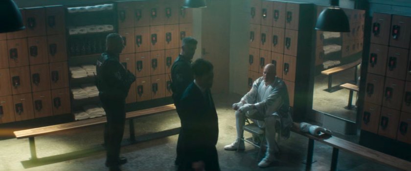 Fisk and his entourage in the locker room of Fogwell's Gym.