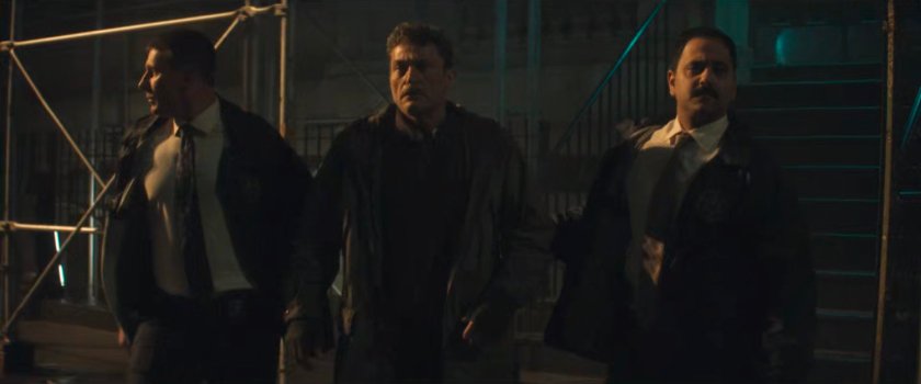 Christofi being escorted from the resistance hideout by two US Marshals.