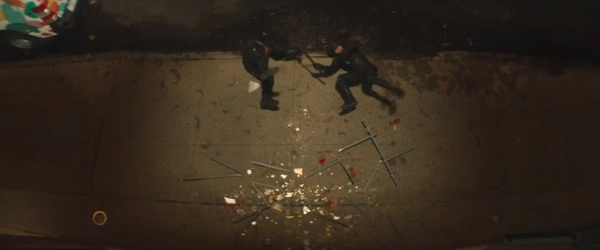 Bullseye and Daredevil laying on sidewalk outside Fogwell's Gym.