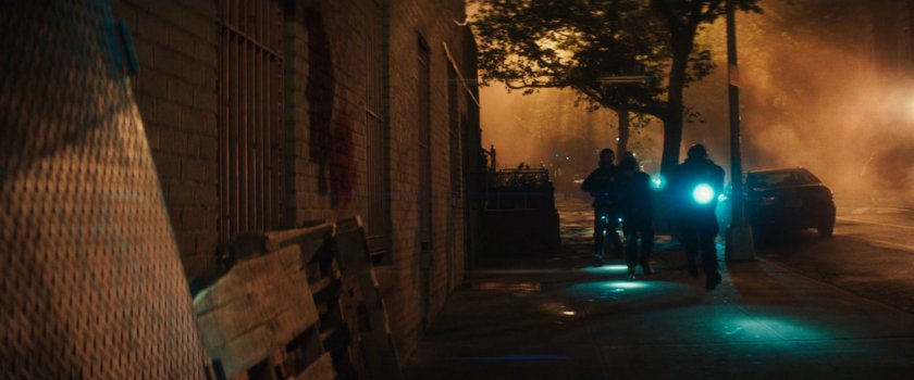 AVTF Officers running along the sidewalk at night.