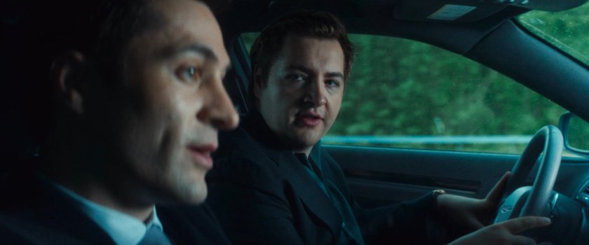 Daniel driving his car, with Buck, along a highway.