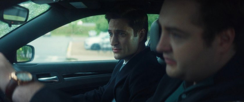 Daniel driving his car, with Buck, along a highway.