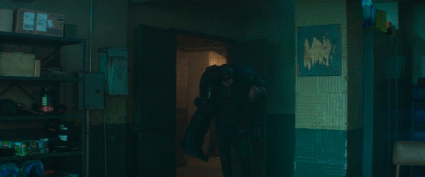 Daredevil carrying Bullseye into Frank's old hideout.