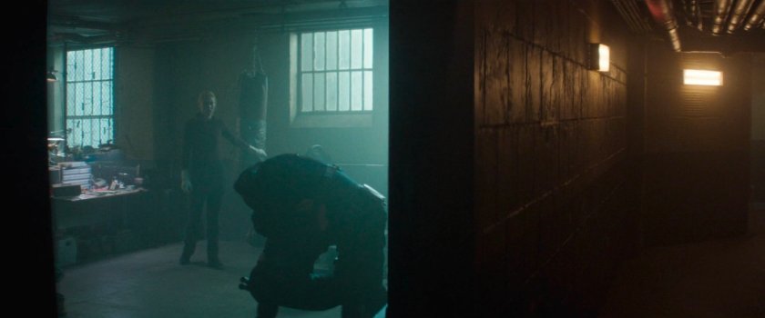 Daredevil carrying Bullseye into Frank's old hideout as Karen looks on.