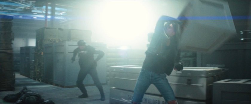 Jessica fighting an AVTF officer in a weapons storage warehouse.