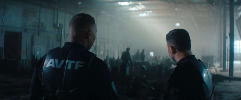 Cole and Powell in a weapons storage warehouse.