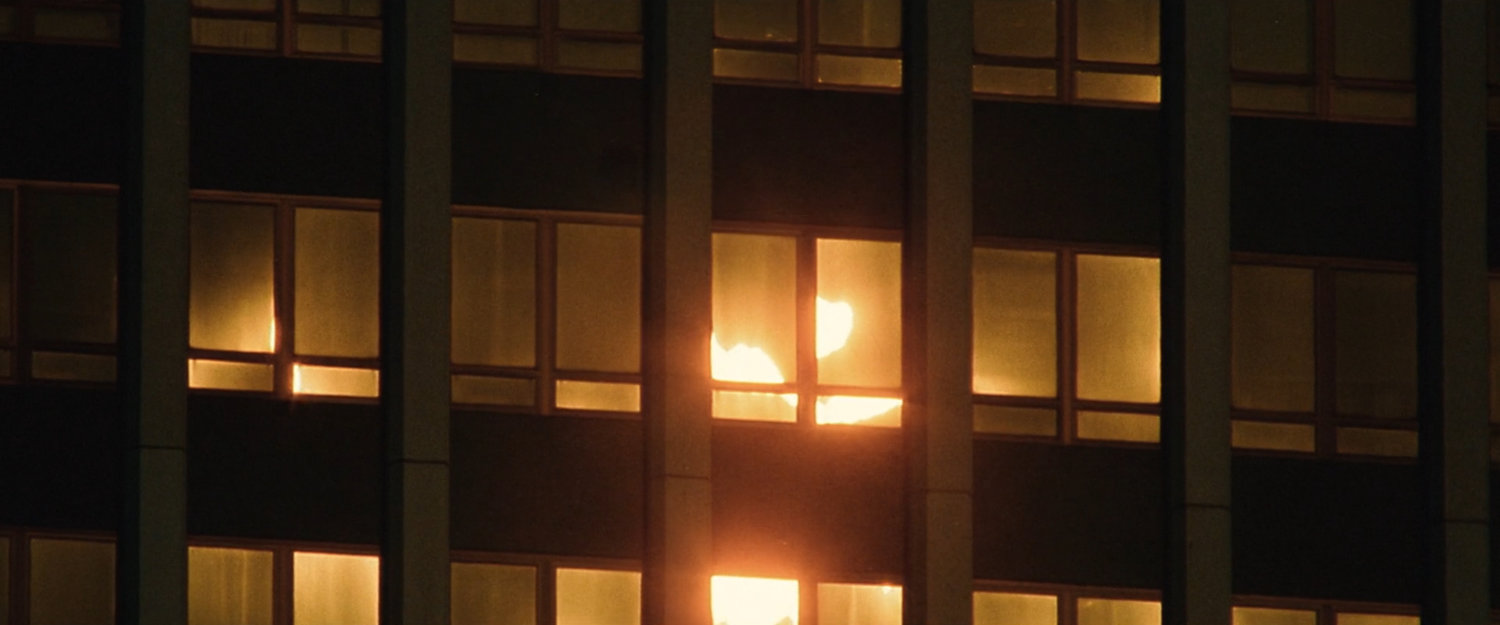 Interstitial: Sunrise reflected on building.