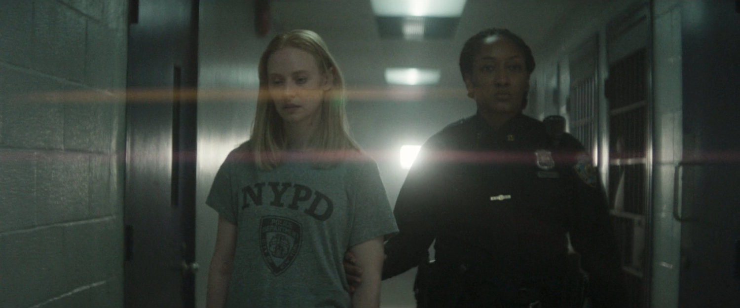 Karen escorted down the hall at the 15th Precinct.