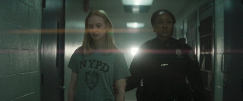 Karen escorted down the hall at the 15th Precinct.