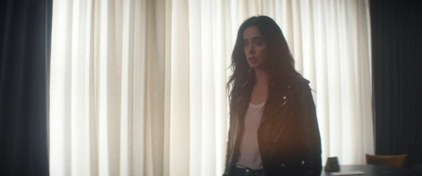 Jessica Jones in Mr. Charles's apartment.