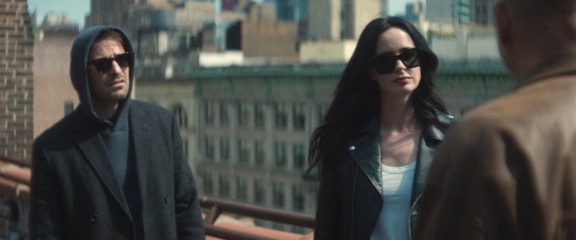 Matt, Jessica, and Cherry discuss next steps on a city rooftop.