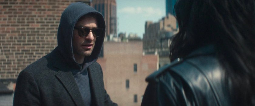 Matt and Jessica discuss next steps on a city rooftop.