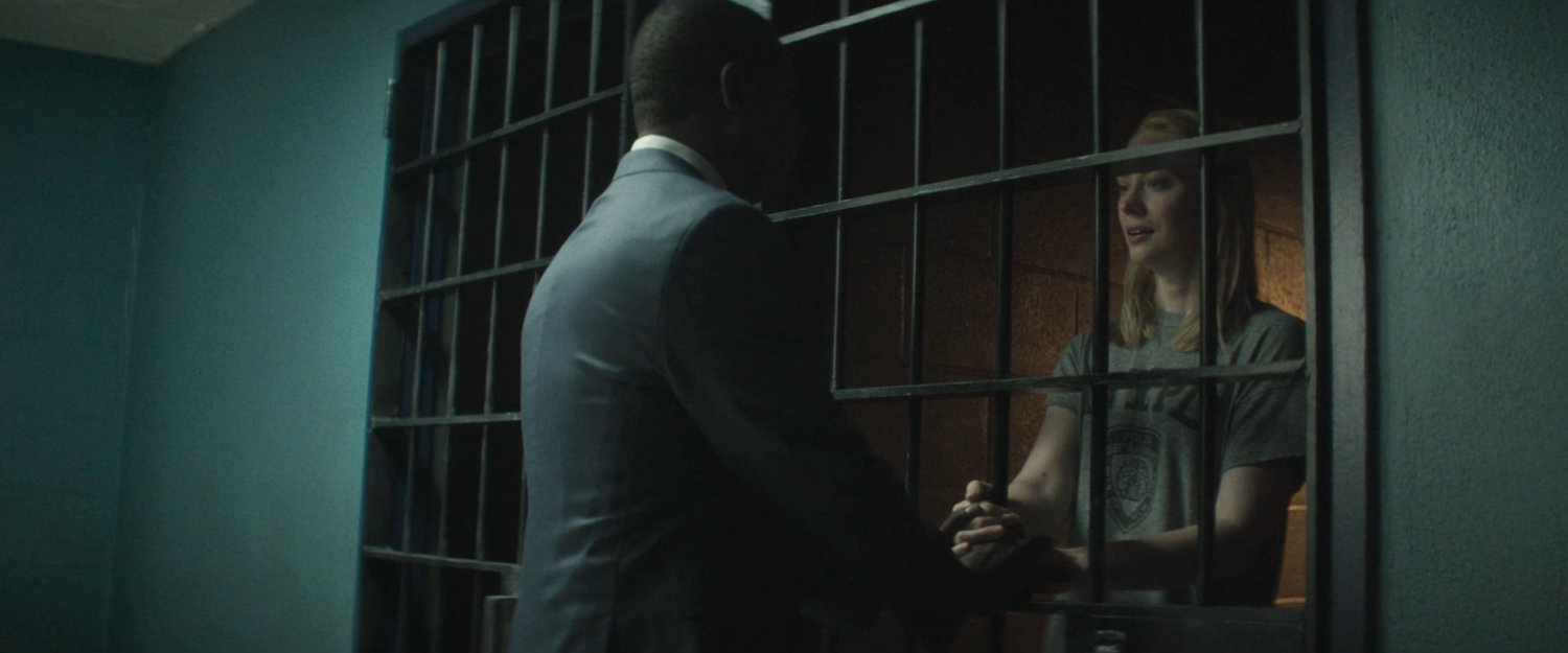 Detective Mahoney speaking with Karen in a holding cell at the 15th Precinct.