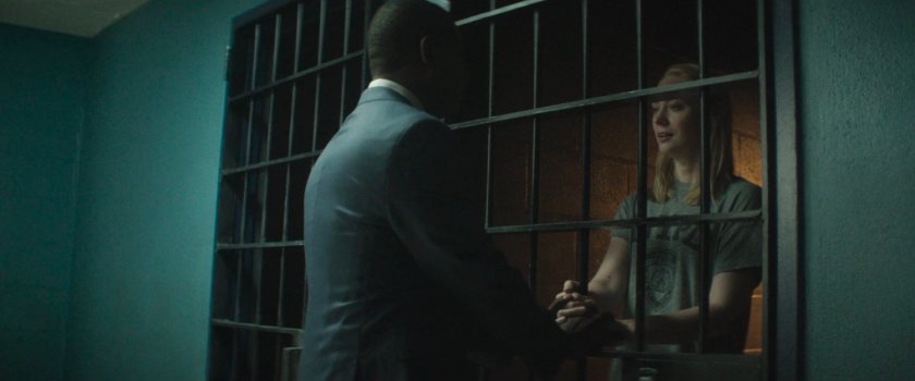 Detective Mahoney speaking with Karen in a holding cell at the 15th Precinct.