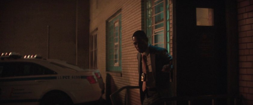 Mahoney stepping out the back entrance to the 15th Precinct.