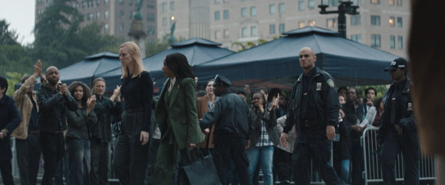Kristen escorts Karen into a city courthouse amongst a crowd of citizens.
