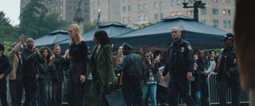 Kristen escorts Karen into a city courthouse amongst a crowd of citizens.