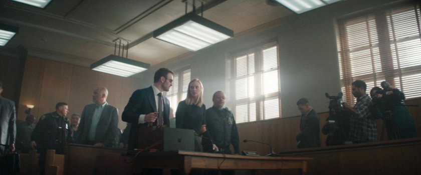Matt and Karen in a crowded city courtroom.