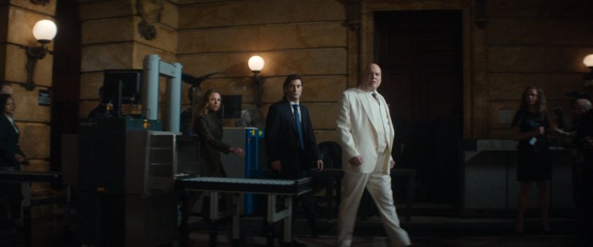 Fisk, Buck, and Heather walk through the city courthouse lobby.