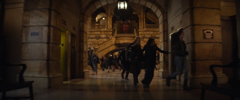 Crowds running through the city courthouse lobby.
